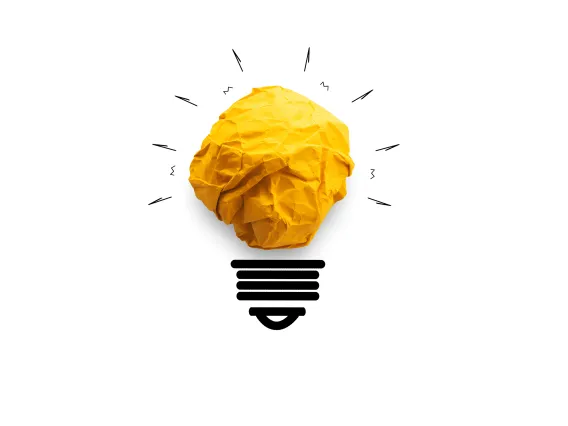 Lightbulb with crumpled yellow paper with light