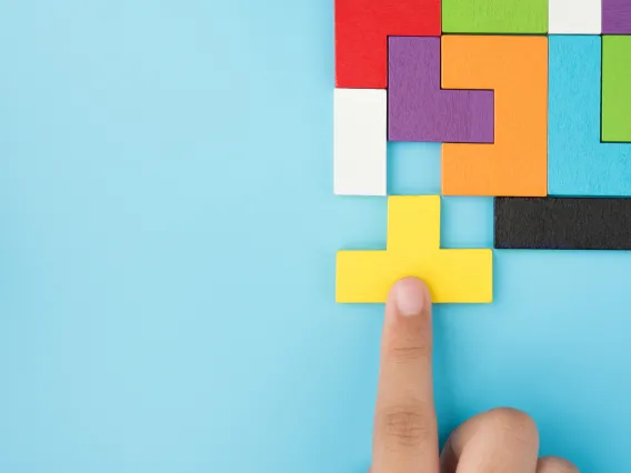 Person putting multiple shaped blocks together